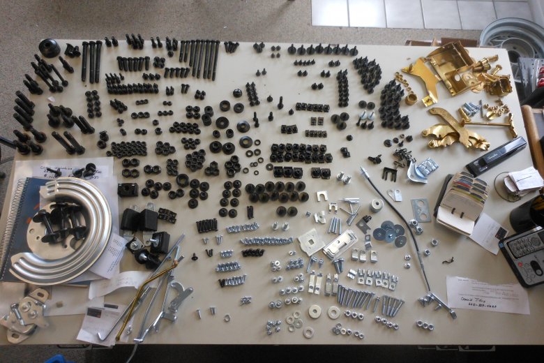 Here we have all the bolts, nuts, washers, screws, and other parts back from the plater and sorted so they can all be put back on the car just as they came off.