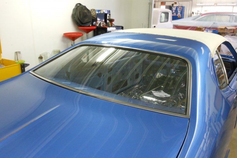 Here we put in the rear window and stainless trim.