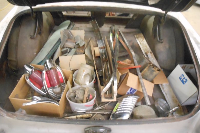 Many pieces that were taken off the car were put into the trunk.