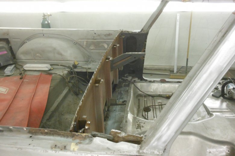 Here we had to completely cut out the lower rear window sill and the package tray because they were so rusted.