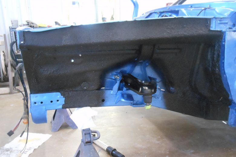 Here the inner fender is undercoated and the upper control arm is installed.